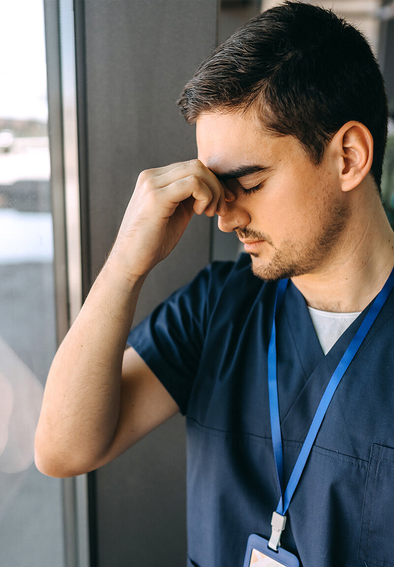 A stressed veterinarian dealing with grief